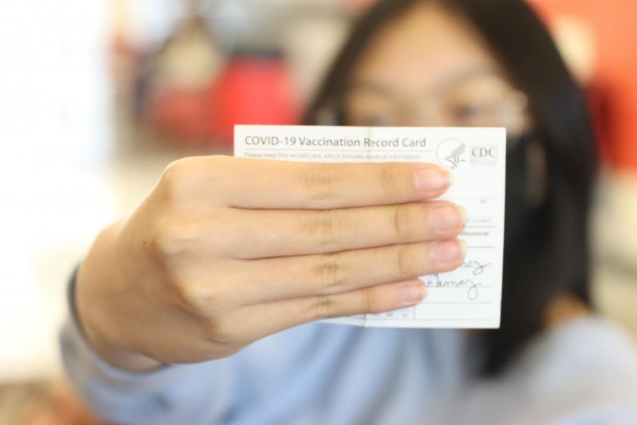 A Bullitt East student displays vaccination card.