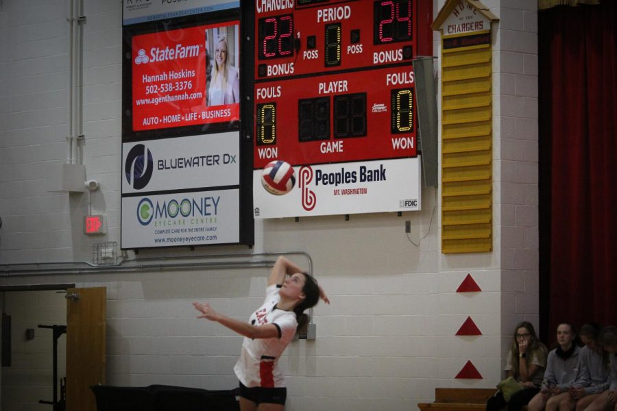 Sophomore Caroline Harbolt serves in the third set currently tied 1-1 against Bullitt Central.