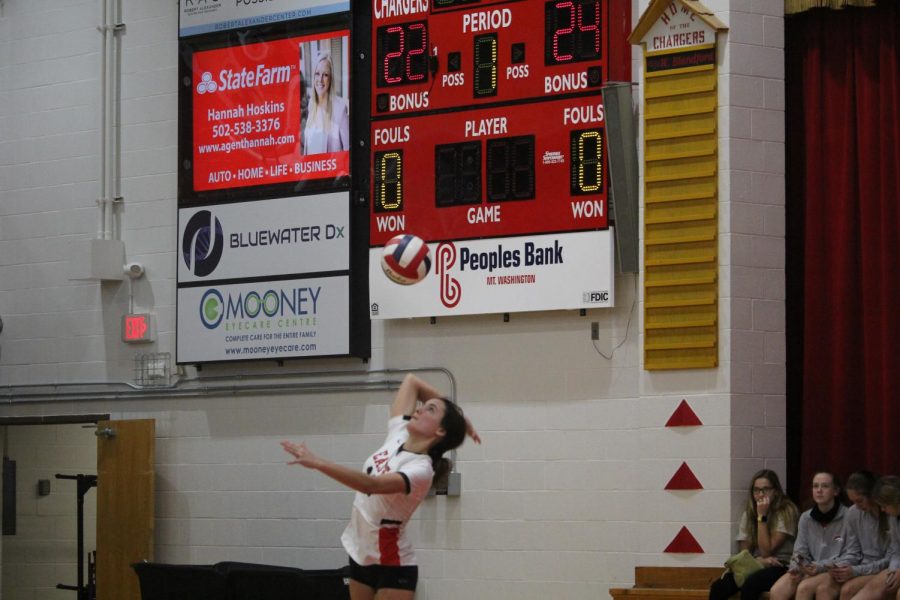 Sophomore Caroline Harbolt serves in the third set currently tied 1-1 against Bullitt Central.