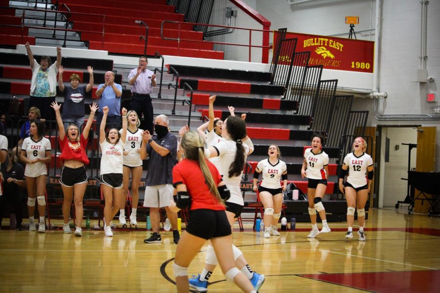 The volleyball team celebrates as they win 3-1 against Bullitt Central. "It was amazing to beat Bullitt Central after losing last year," junior Layla McAuliffe said. 