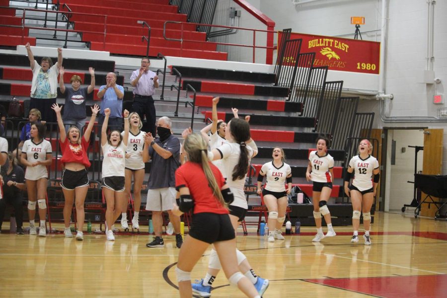 The volleyball team celebrates as they win 3-1 against Bullitt Central. "It was amazing to beat Bullitt Central after losing last year," Junior Layla McAuliffe said. 