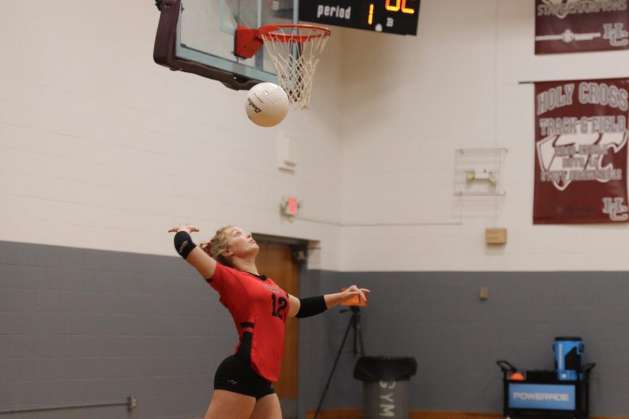 Senior Morgan Butler serves in the first round of the six region tournament. The Lady Chargers played Holy Cross Oct. 25, Holy Cross won 3-1. Our last game against Holy Cross definitely couldve ended in our favor but they are also a very good team, Butler said.