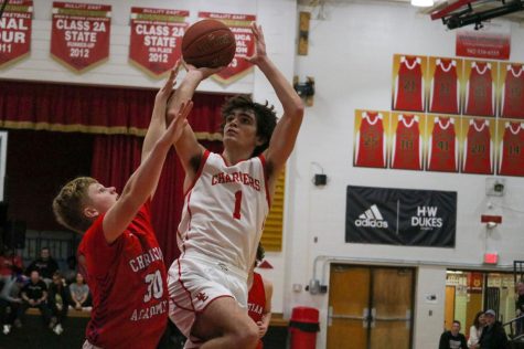 Senior Adam Pruitt shoots for a layup. The boys played Christian Academy of Louisville Jan. 25 and won 81-62. We had a practice on Wednesday that hopefully got their attention and got our minds right,  Coach Coach said. 