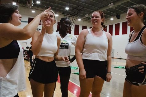 As the color guard works hard, they take time to bond and create friendships. The teammates have a pep talk as they work together to fix their mistakes. “We learn how to push through and keep going,” Kendall McGarry said. From left to right: Kiara Warren, Ellen Bray, Jenascia Hargrove, Skylar Braden, Kendall McGarry. Photo Credits: Milana Ilickovic 
