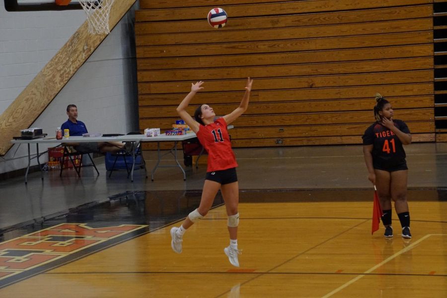 Junior Caroline Harbolt serves during the game at Fern Creek. The team has come a long way since the first game, and they are focusing on their individual strengths. “I think weve come really far, weve connected as a team, we’ve figured each other out, we play better with each other,” Cissell said. Photo Credits: Bryce Elder