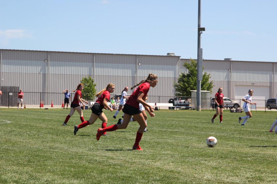 Three players rush near the ball. This season, the team has been focusing more and more on communication. For the rest of the season I think we need to work on our communication skills because its something weve really been struggling with during games, junior Tessa Tibone said. 
