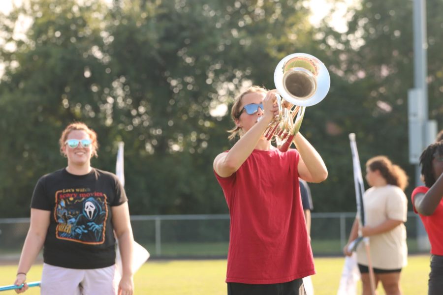 Marching band members practice hard in the heat. The band had their first performance at Columbus North High School on Sept. 10. "We're really excited for the new season, especially with the show we have," senior colorguard member Kendall McGarry said. Photo Credit: Natalie McGarry