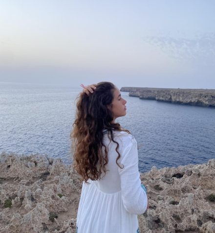 Sophomore foreign exchange student Maria Acros in front of the Mediterranean Sea in Menorca, Spain.