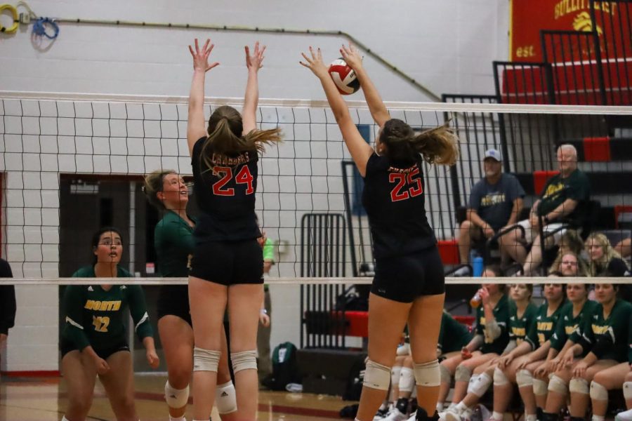 Emma Brogan going up for a block. Katherine Cissell is next to her. We all had a lot more determination to win that game because it was a rival, senior Hayla Puckett said