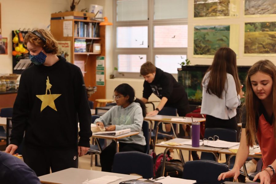 Students sit down for class with one choosing to mask for protection from COVID-19. Despite being in fewer numbers, some students still do choose to wear masks. Masks were good at regulated COVID last year, but I dont think they should be required, Jonathan Huether said. 