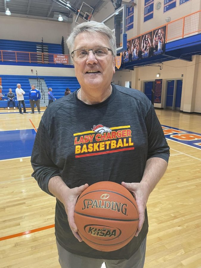 Head Coach, Chris Stallings holding game ball of his 500th Bullitt East Girls Basketball season win.