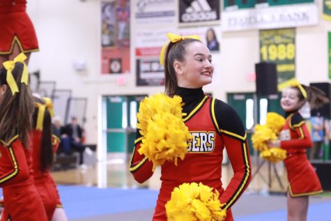Senior Carly Snellen cheering during a performance. The cheer team had a competition Jan. 7. “I felt great about what we put on the floor because we finally hit a lot of the skills we had been struggling with for the past few weeks,” Snellen said. Photo Credit: Natalie McGarry