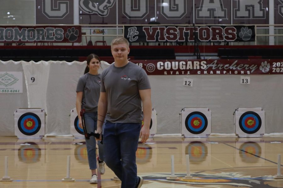 Seniors Rachel Lagermann and Alex Schmidt walk back to the team after finishing their last shot at the Bullitt Central Winter Warm Up tournament. 