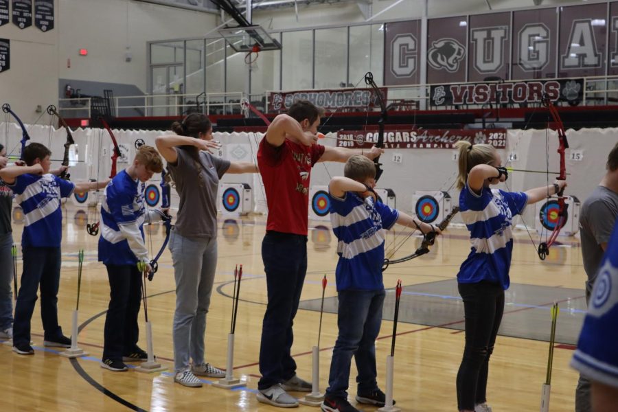 Senior Evan Sexton aims his arrow to shoot at the target from the 15 yard line. 