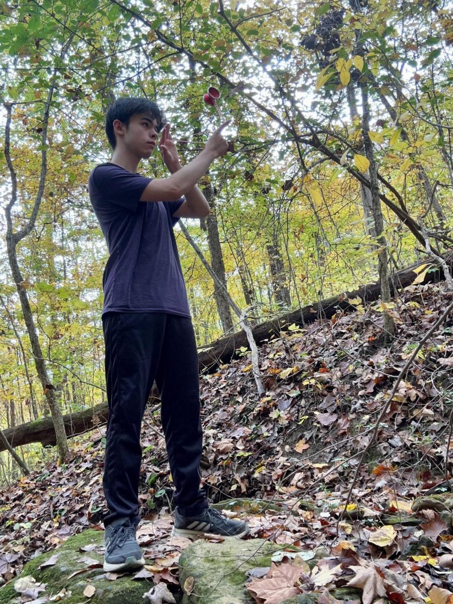 Jonas Greenhalgh does a "1.5 direct" yo-yo trick in a forest behind his house as he practices yo-yoing.