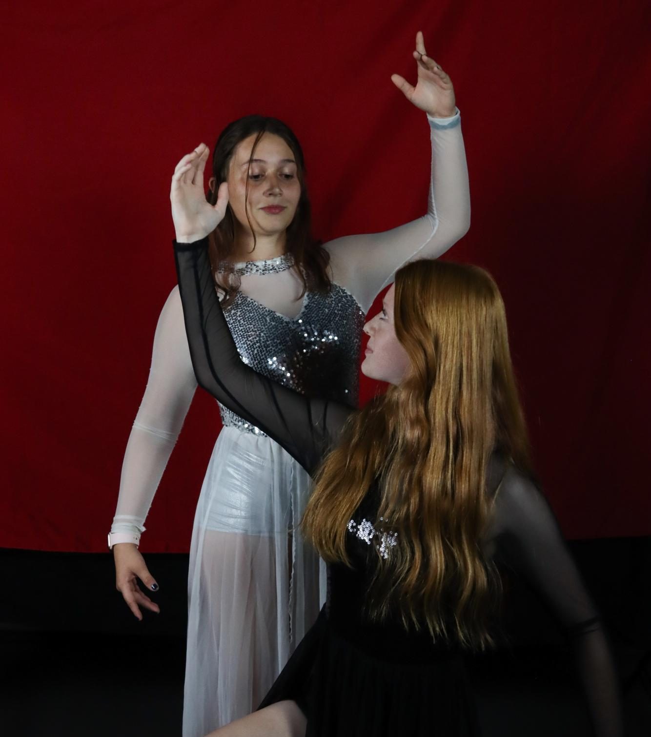 Savannah Bayton and Molly Rushing pose abstractly for winter guard. Bayton and Rushing have been looking forward to spending time with their fellow members this new season. My favorite thing is to be with all the people that I love, and I get to hang out with everyone,” Rushing said.
