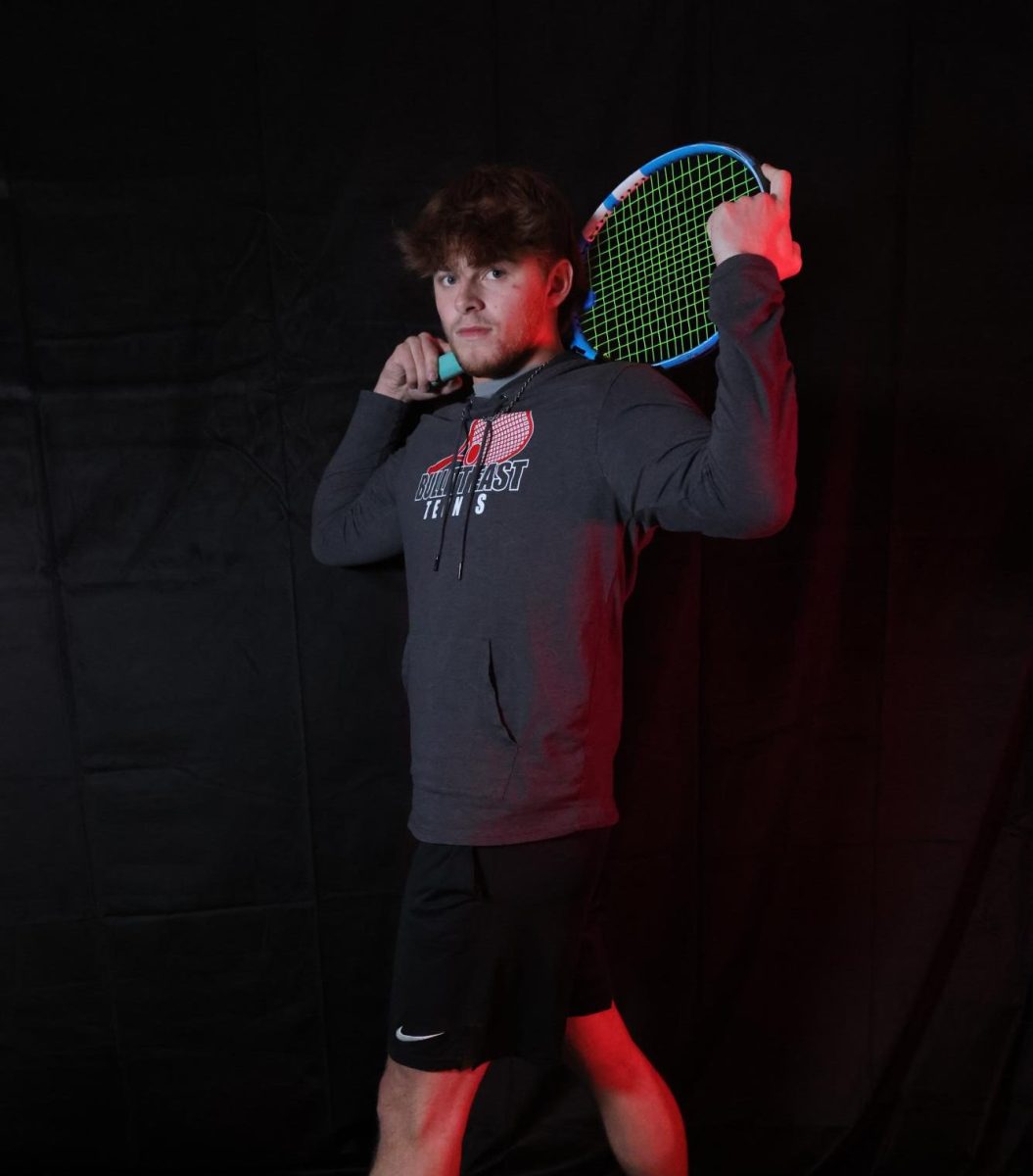 Senior Andrew Kruse prepares for upcoming regionals as well as the end of tennis season. "I've had the opportunity to go play for a chance of a state title for our school and you get to meet great people." Kruse said.