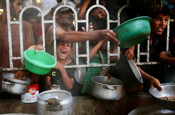 Children begging for food at the nearby aid center in Gaza, July 22.                                                  
