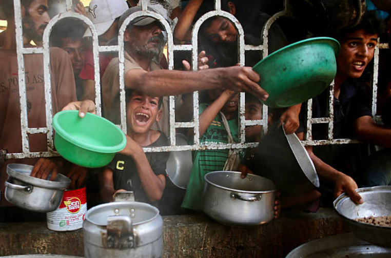 Children begging for food at the nearby aid center in Gaza, July 22.                                                  
