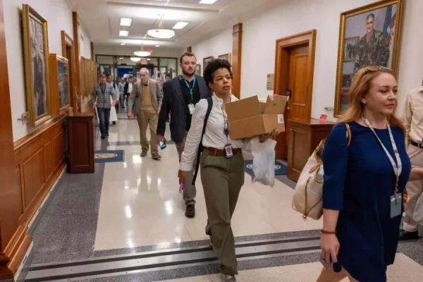 Members of the Pentagon press walk out of the Pentagon as a group after turning in their press credentials on Oct. 15. 
